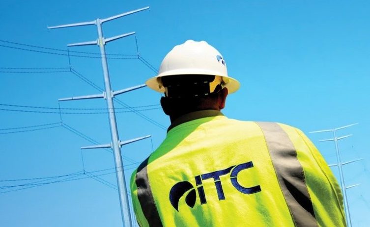 An ITC employee with a transmission tower.