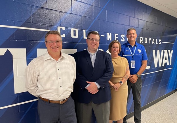 Four power of connection recipients from Colo-Nesco School standing in front of blue wall.