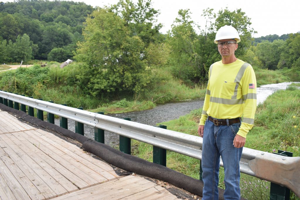 Construction worker in hard hat standing on bridge