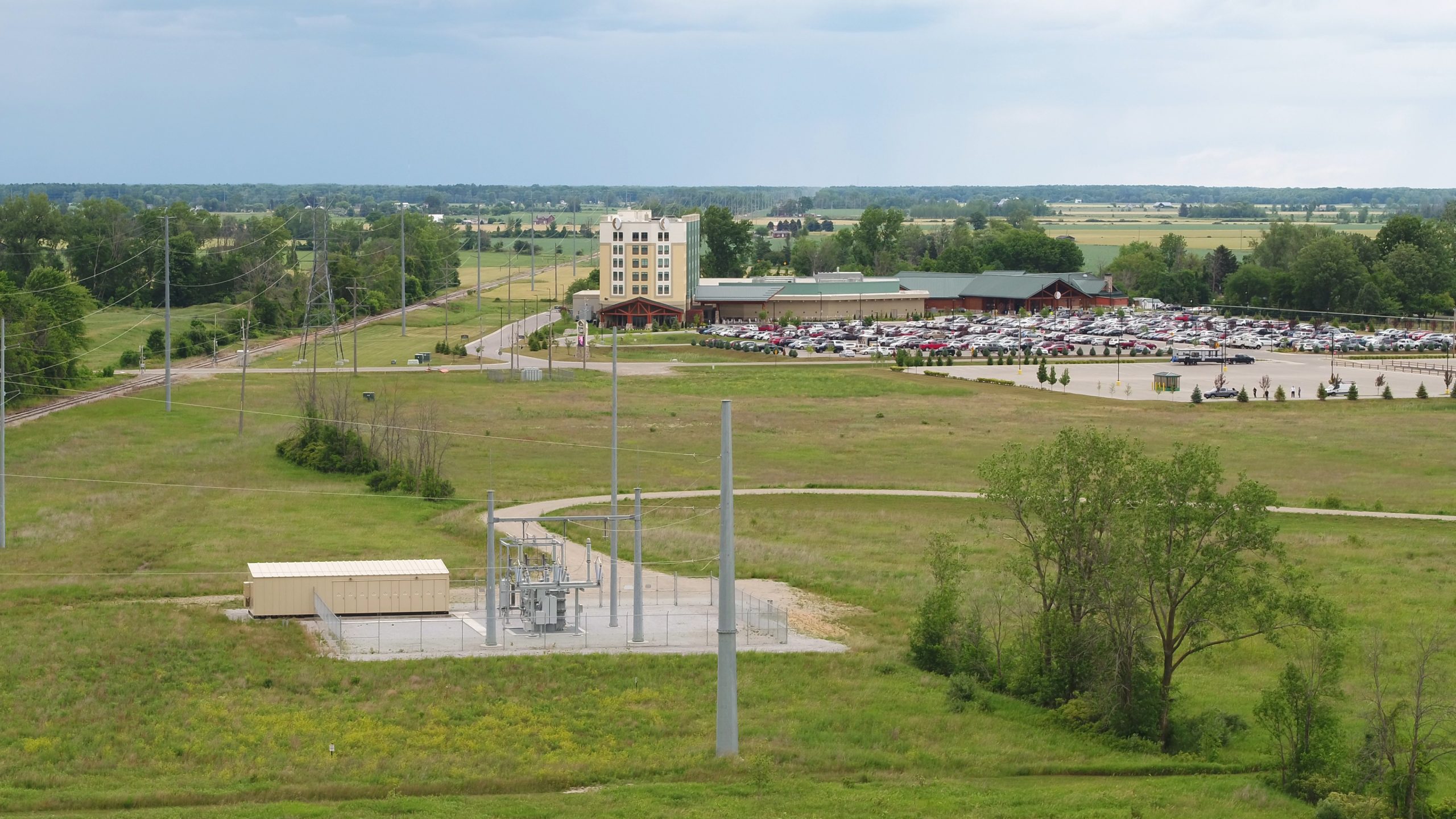 Landscape image of energy substation with casino in the distance. Image