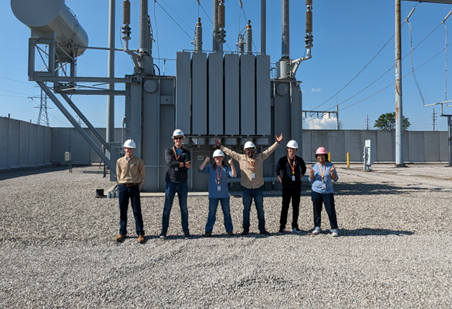 Six young adults in front of transmission station