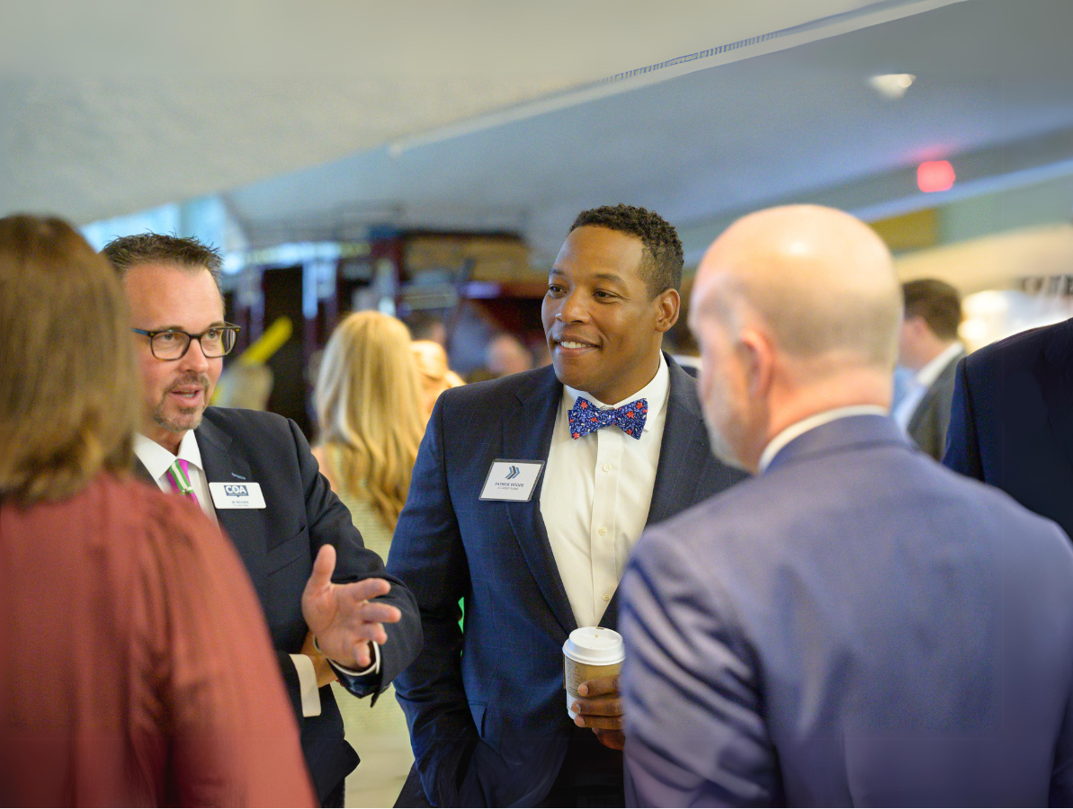Two ITC representatives talking to community members at event.