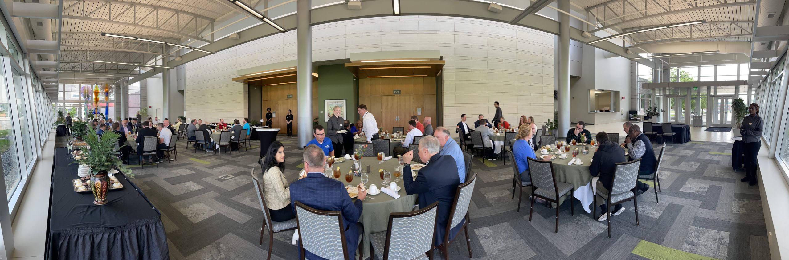 Group of community members seated for meal during ITC Midwest's Spring Partners in Business Meeting.