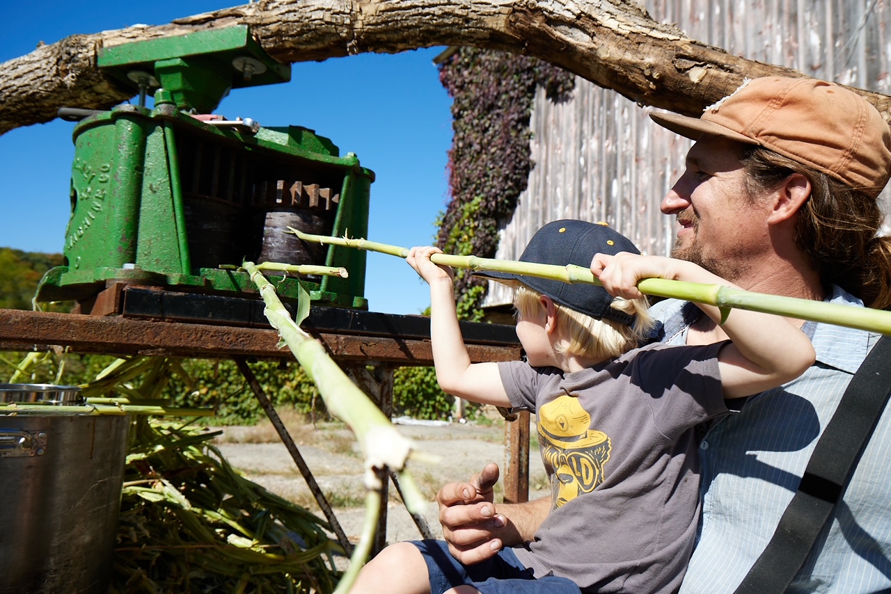 Two people handling farm equipment in Iowa.