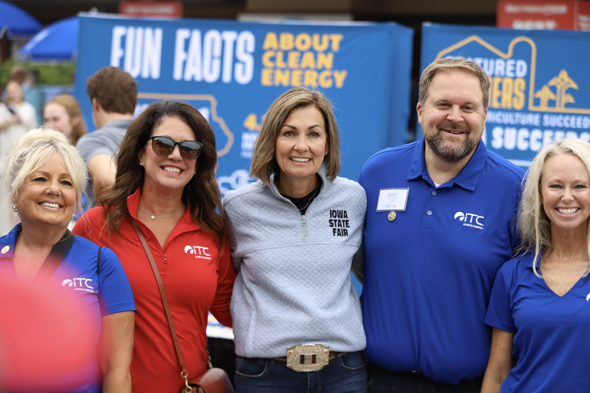 Group of four ITC employees posed for a picture with the Governor of Iowa at the Iowa State Fair.