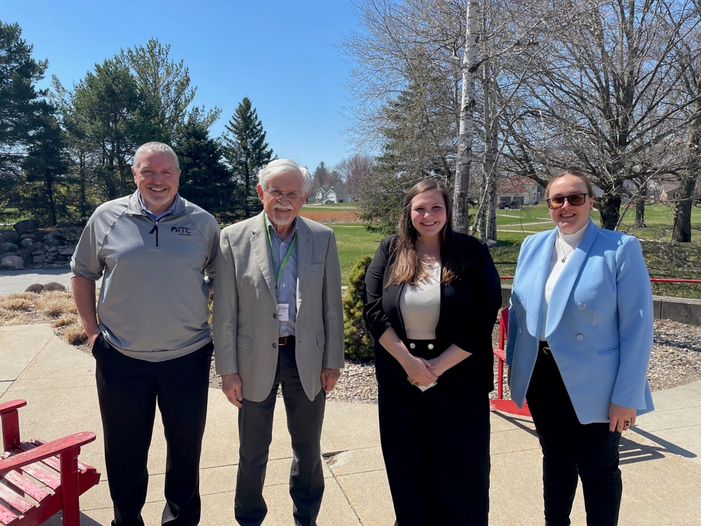 Group of four individuals standing outside of park.