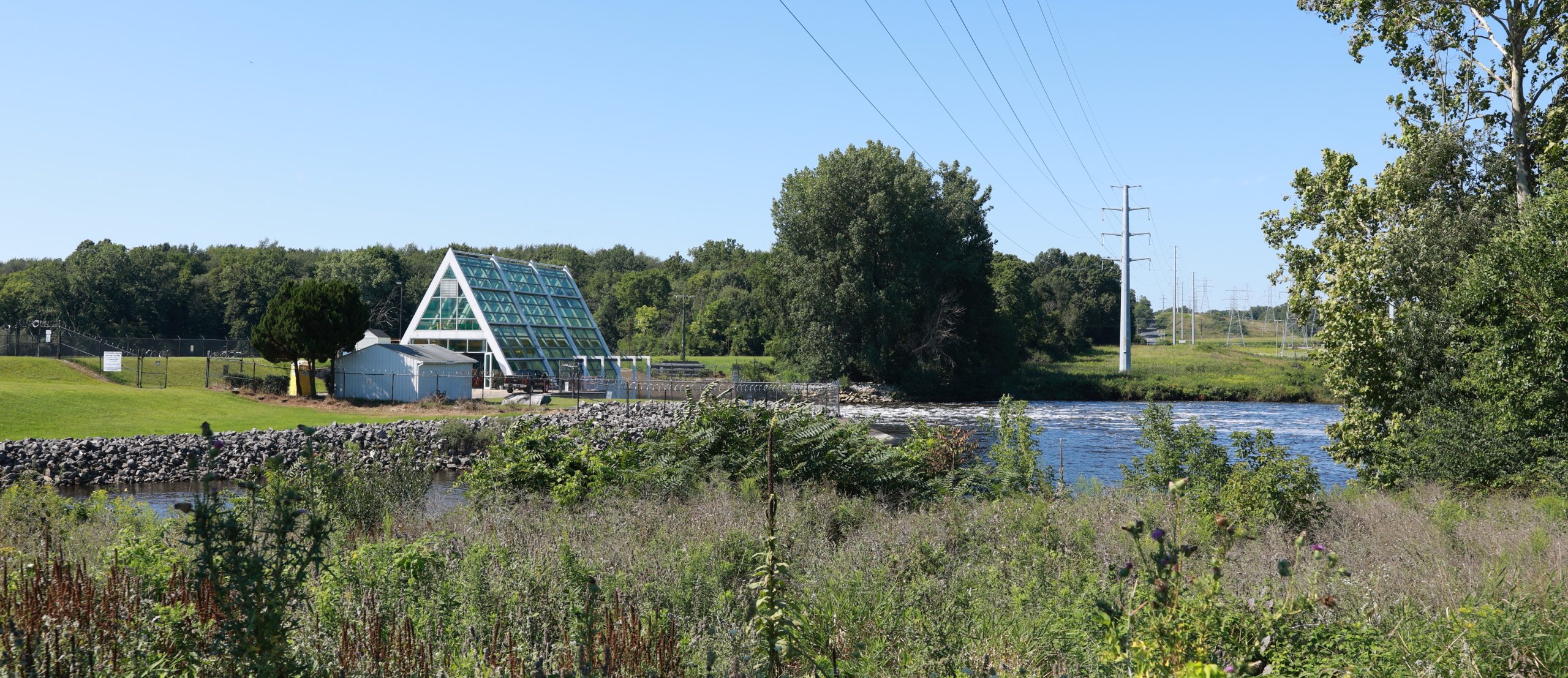 Landscape shot of transmission infrastructure next to hydro plant.
